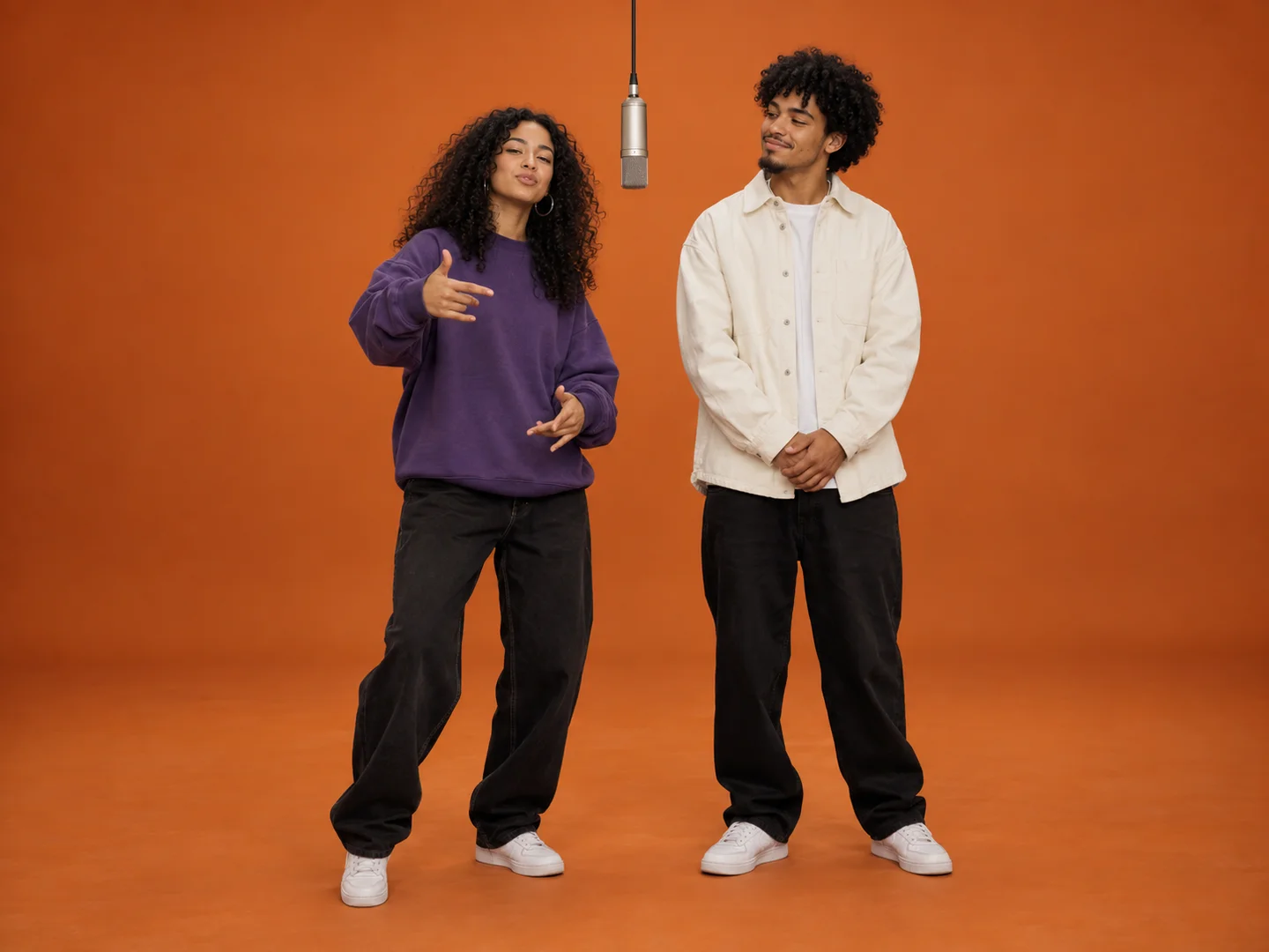 Adult siblings playfully trading verses in the orange studio